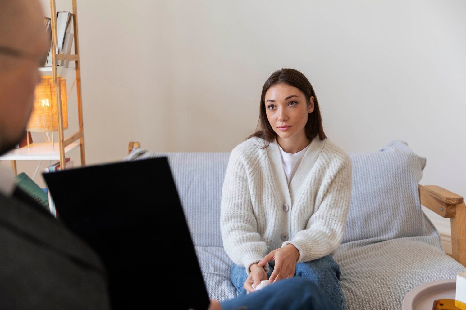 Woman answering a provider’s questions during a psychiatric evaluation